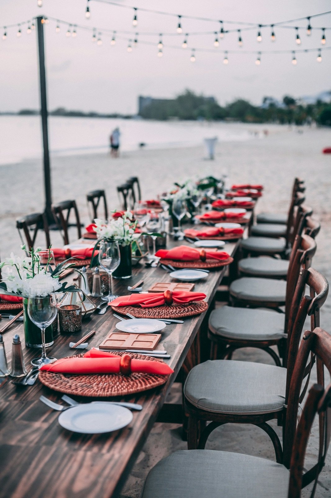 Long dinner table set up on a beach in Cuba